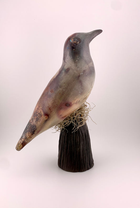 Ceramic Bird barrel fired on a stand